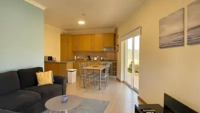 a living room with a couch and a kitchen at Oura Oasis A by Check-in Portugal in Albufeira
