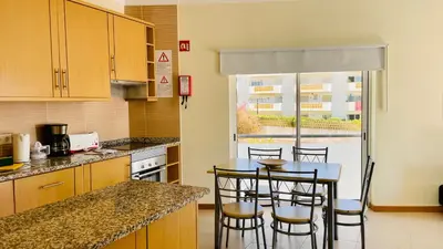 a kitchen with a table and some chairs in it at Oura Oasis D by Check-in Portugal in Albufeira