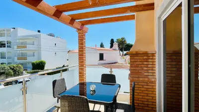 a patio with a blue table and chairs on a balcony at Oura Oasis D by Check-in Portugal in Albufeira