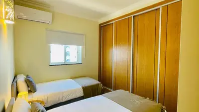 a small room with two beds and a window at Oura Oasis E by Check-in Portugal in Albufeira