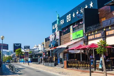 a city street with many shops and buildings at Oura Oasis E by Check-in Portugal in Albufeira