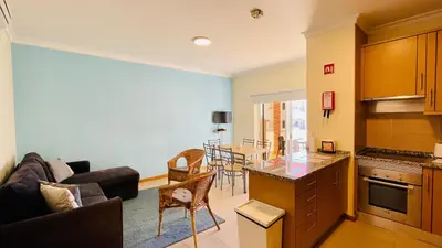 a kitchen and living room with a couch and a table at Oura Oasis E by Check-in Portugal in Albufeira