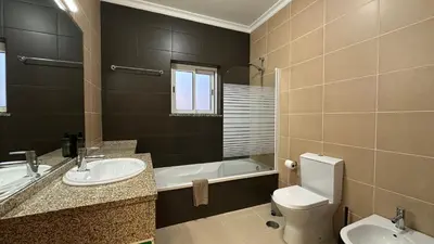 a bathroom with a toilet and a sink and a tub at Oura Oasis F by Check-in Portugal in Albufeira