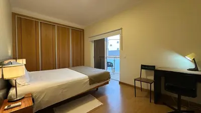 a bedroom with a bed and a desk and a window at Oura Oasis F by Check-in Portugal in Albufeira