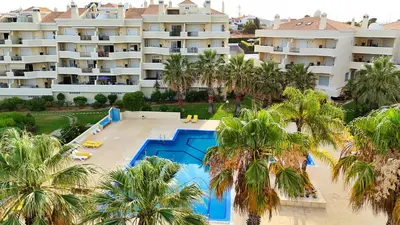 an aerial view of a resort with a pool and palm trees at Sao Rafael Beach Luxury Home by Be Cherish in Albufeira