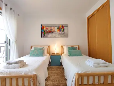 two beds sitting next to each other in a room at Sao Rafael Beach Luxury Home by Be Cherish in Albufeira