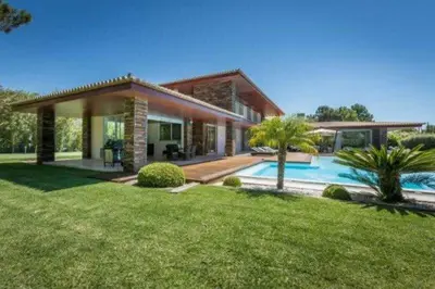 a house with a swimming pool in a yard at Villa Atlantic Pearl - Luxury villa located in in Quinta do Lago