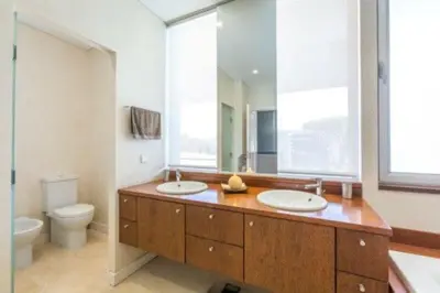 a bathroom with two sinks and a toilet at Villa Atlantic Pearl - Luxury villa located in in Quinta do Lago