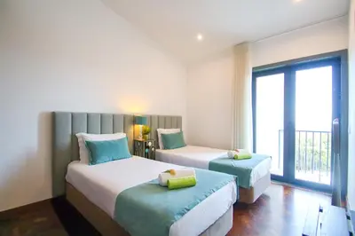 a bedroom with two beds with blue and yellow pillows at Villa Blue Lagoon by Algarve Vacation in Albufeira