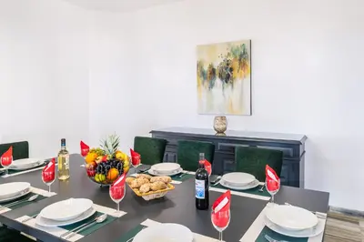 a dining table with a bowl of fruit and wine glasses at Villa Blue Lagoon by Algarve Vacation in Albufeira