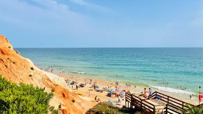 a group of people on a beach near the ocean at Moon by Check-in Portugal in Albufeira