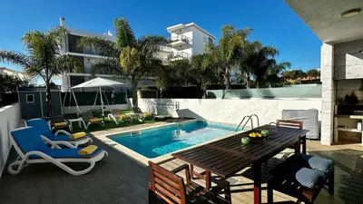 a patio with a table and chairs next to a swimming pool at Moon by Check-in Portugal in Albufeira