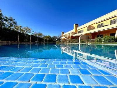 a swimming pool in front of a building at Vilamoura Paradise Golf With Pool by Homing in Vilamoura