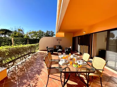 a patio with a table and chairs on a balcony at Vilamoura Paradise Golf With Pool by Homing in Vilamoura