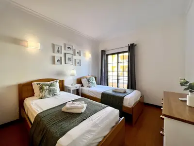 a hotel room with two beds and a window at Vilamoura Paradise Golf With Pool by Homing in Vilamoura