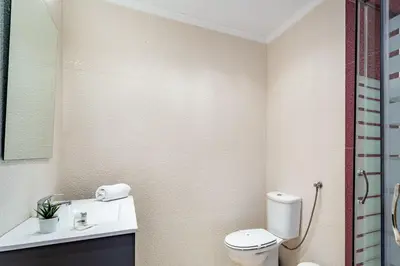a bathroom with a toilet and a sink at Duas Palmeiras by LovelyStay in Albufeira