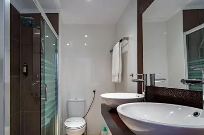 a bathroom with a tub and a sink and a toilet at Duas Palmeiras by LovelyStay in Albufeira