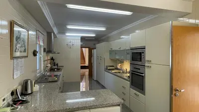 a large kitchen with white cabinets and appliances at Azaleas by Check-in Portugal in Vilamoura