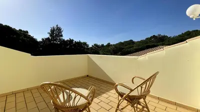 two chairs on a balcony with a white wall at Azaleas by Check-in Portugal in Vilamoura