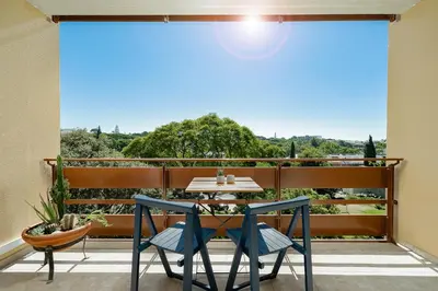 a table and chairs on a balcony with a view at Estúdio do Largo - Vilamoura in Vilamoura