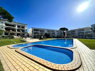 a large swimming pool in front of a building at Vilamoura Garden View 1 With Pool by Homing in Vilamoura