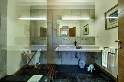 a bathroom with a sink and a tub and a mirror at Villa Mauri Luxe - Beautiful beachfront villa in Albufeira