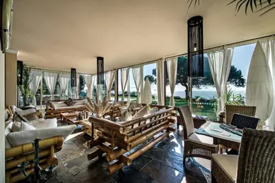 a living room with a lot of furniture and windows at Villa Mauri Luxe - Beautiful beachfront villa in Albufeira