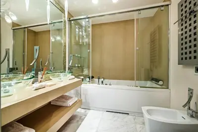 a bathroom with a tub and a sink at Villa Plage Grande - Superstar luxury - Beachtop in Olhos de Água