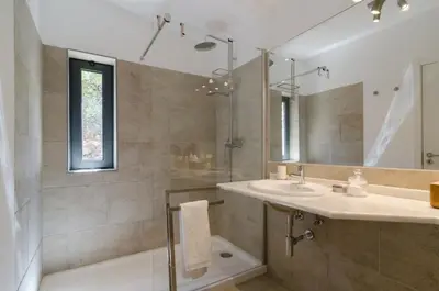 a bathroom with a tub and a sink and a mirror at Villa Colom in Quarteira
