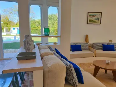 a living room with a couch and a table at Superb Vilamoura Villa 5 Bedrooms Villa Azul Walking Distance To Marina in Quarteira