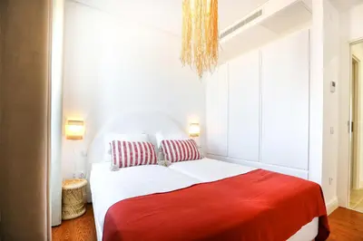 a bedroom with a bed with a red blanket at Tropical Flavour Apartment in Faro