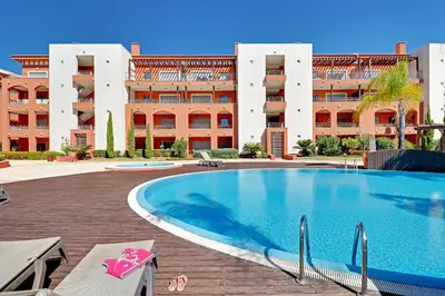 a large swimming pool in front of a building at Victoria Secret in Vilamoura