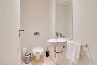 a white bathroom with a sink and a toilet at Victoria Secret in Vilamoura