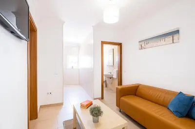 a living room with a couch and a table at Casa Negril by Algarve Vacation in Albufeira