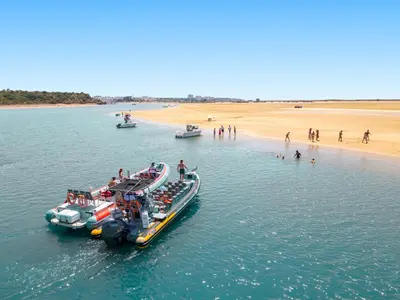 two boats in the water next to a beach at Casa Negril by Algarve Vacation in Albufeira