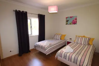 a room with two beds and a window at Modern Vilamoura Villa Close To Pinhal Golf Villa Maelou 4 Bedrooms in Quarteira