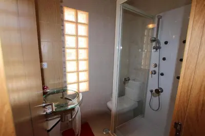 a bathroom with a glass sink and a shower at Modern Vilamoura Villa Close To Pinhal Golf Villa Maelou 4 Bedrooms in Quarteira