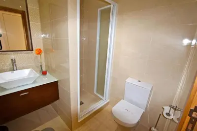 a bathroom with a shower and a toilet and a sink at Contemporary Portuguese Villa 4 Bedrooms Villa Violeta Private Pool in Quarteira