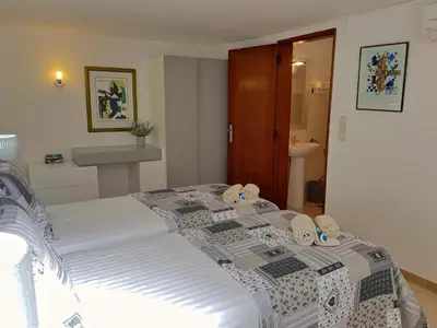 a large bed in a bedroom with a bathroom at Contemporary Portuguese Villa 4 Bedrooms Villa Violeta Private Pool in Quarteira