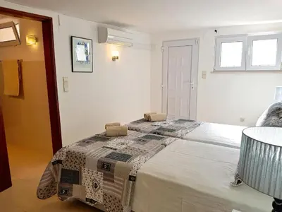 a bedroom with a bed with a quilt on it at Contemporary Portuguese Villa 4 Bedrooms Villa Violeta Private Pool in Quarteira