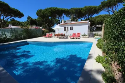 a swimming pool in front of a house at Contemporary Portuguese Villa 4 Bedrooms Villa Violeta Private Pool in Quarteira
