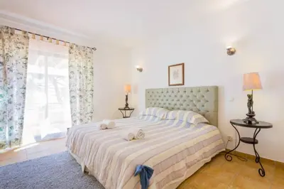 a bedroom with a large bed with towels on it at Beach House (Golf) - Falésia/Albufeira in Albufeira