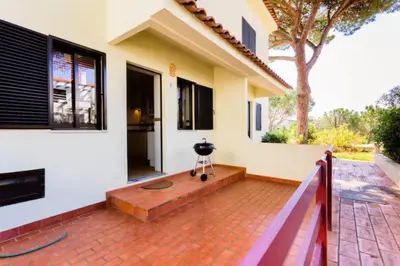 a house with a camera on a brick patio at Beach House (Golf) - Falésia/Albufeira in Albufeira