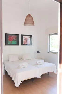 two beds in a room with white walls at Beautiful private Villa with pool, Boliqueime, Loulé in Boliqueime