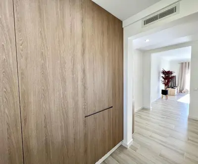 a large wooden door in a room with a hallway at Oceanview - Sea front by HD PROPERTIES in Quarteira