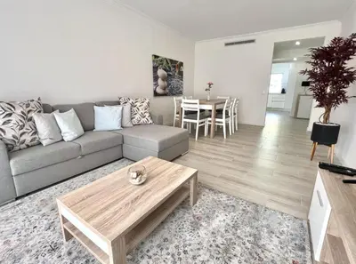 a living room with a couch and a table at Oceanview - Sea front by HD PROPERTIES in Quarteira