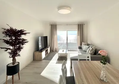 a living room with a couch and a table at Oceanview - Sea front by HD PROPERTIES in Quarteira