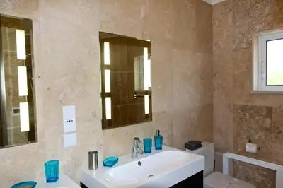 a bathroom with a sink and a mirror and a toilet at Luxury Vilamoura Villa 4 Bedrooms Villa Corvo Billiards in Quarteira