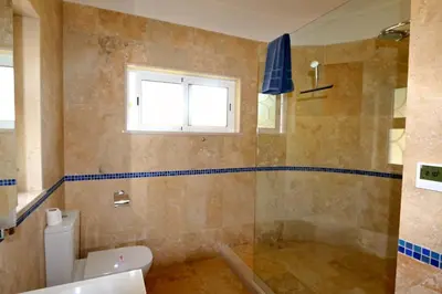 a bathroom with a shower and a toilet and a window at Luxury Vilamoura Villa 4 Bedrooms Villa Corvo Billiards in Quarteira