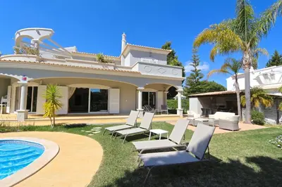 a villa with a swimming pool and a house at Luxury Vilamoura Villa 4 Bedrooms Villa Corvo Billiards in Quarteira